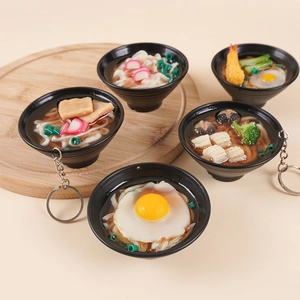 Five styles of 7cm artificial udon and ramen noodle bowl keychains on a wooden tray
