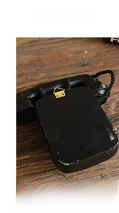 Detail view of the flat back and golden mounting hook of the vintage resin telephone model