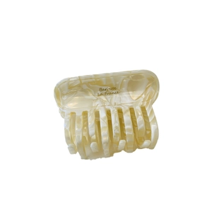 Elegant beige acetate marble-patterned claw clip with bow-shaped ribbon design