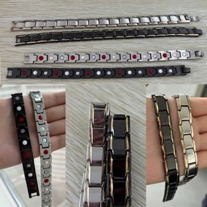 Detail view of magnetic therapy bracelets showing black and gold link patterns and magnets