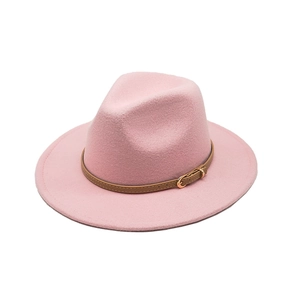 Close-up of pink felt fedora hat featuring a brown leather strap with golden buckle detail
