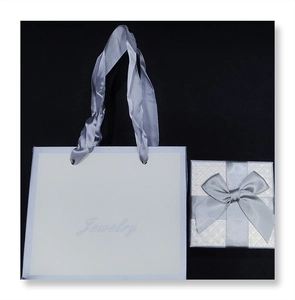 Elegant white jewelry gift set with square ribbon box and matching paper carrier bag