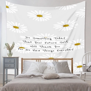 Detail showing white daisy patterns and motivational English quotes on wall tapestry