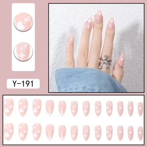 Pink almond press-on nails set with white heart and star patterns for a sweet look