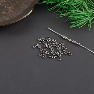 Macro view of silver faceted metal beads on a wire for DIY jewelry making accessories