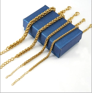 Detailed view of four different widths of 18K gold plated stainless steel dragon chain bracelets