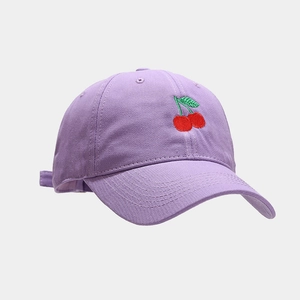 Detail of light purple baseball cap featuring high-quality red cherry embroidery on cotton