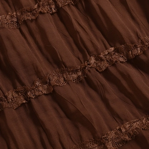 Detailed view of brown pleated fabric featuring delicate lace trim and rich textures