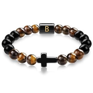 Detail of tiger eye bead bracelet featuring a black cross charm and golden letter B bead