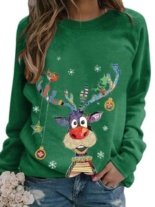 Detailed view of Christmas reindeer and snowflake print on a dark green crewneck sweatshirt