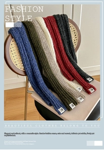 Detail of multi-color thick knit wool scarves with minimalist F-letter fabric labels
