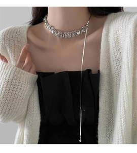 Close-up of a silver wheat tassel choker necklace with a long snake chain pendant drop