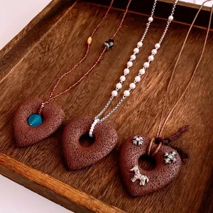 Three minimalist heart pendant necklaces with zircon beads and volcanic stone texture