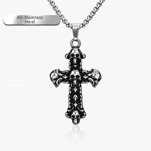 Detailed view of vintage silver stainless steel skull cross pendant on a link chain