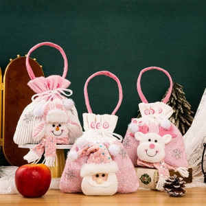 Detailed view of pink knitted Christmas gift bags with 3D Santa, snowman and deer figures