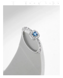 Macro shot of S925 sterling silver ring with square blue stone and micro-pave crystals