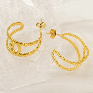 Minimalist gold double-layered geometric earrings with beaded texture on white silk fabric