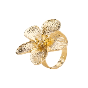 Macro shot of gold floral ring featuring brushed metal texture and open adjustable band