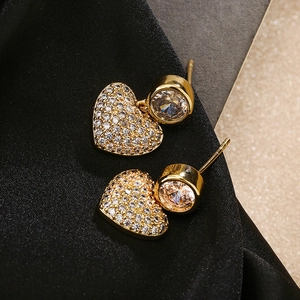 Detailed macro view of 18K gold plated heart earrings with sparkling white zircons