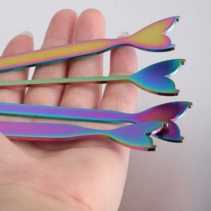 Rainbow mermaid tail stainless steel stirring spoon held in hand showing colorful finish