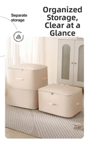 Detail view of beige compression storage bags with sturdy handles and metal zippers for clothes