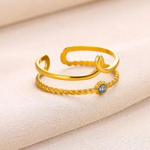 18K gold plated stainless steel teardrop ring with blue gemstone and twisted band design