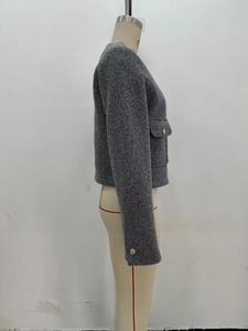 Side view of gray wool coat featuring golden buttons and textured fabric details