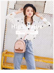 Detail of a pink and brown mini backpack with a gold bow and slim leather shoulder strap