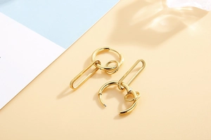 Detail of 18k gold plated multi-layer geometric earrings with U-shaped pendants