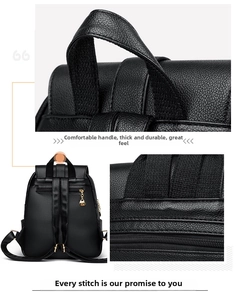 Detail view of black faux leather backpack featuring reinforced handle and anti-theft zip