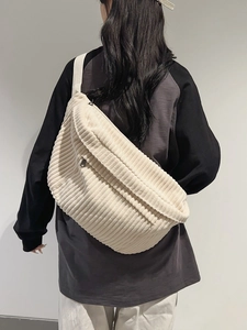 Minimalist beige corduroy crossbody bag with large capacity shown on a model