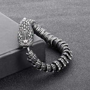 Detail of 304 stainless steel dragon scale bracelet with green gemstone eyes