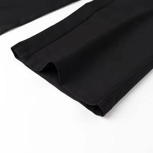 Detail of the hem on black trousers with high-quality fabric texture and neat stitching