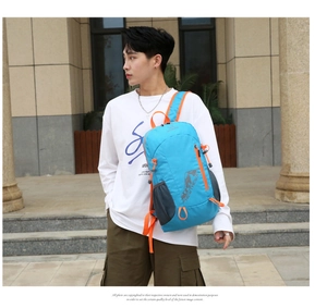 Outdoor sports backpack in bright blue with orange zippers worn by a male model