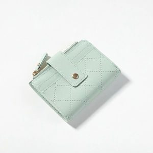 Detail of mint green quilted PU leather wallet with metal zipper and snap closure strap