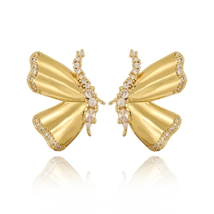 Detailed view of gold butterfly earrings with brilliant zircon inlay and symmetric reflection