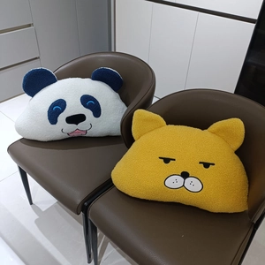 Cute cartoon panda and yellow cat plush pillows on brown leather chairs