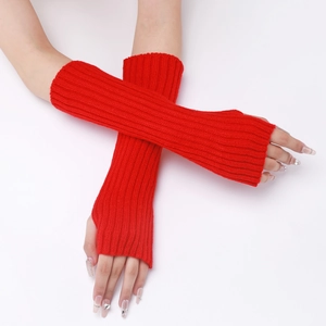 Detail of red cable-knit fingerless gloves showing thick texture and arm-warming length