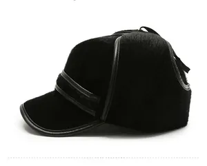 Side view detail of a thick black faux fur trapper hat with leather piping accents