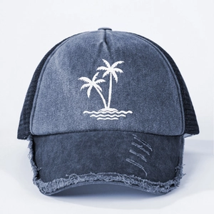 Navy washed denim trucker hat with coconut tree embroidery and distressed brim details