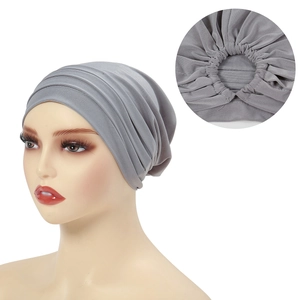 Detailed close-up showing the inner stitching and elastic band of the grey turban hat
