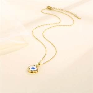 Gold clover necklace featuring blue evil eye pendant with micro-pave cubic zirconia crystals