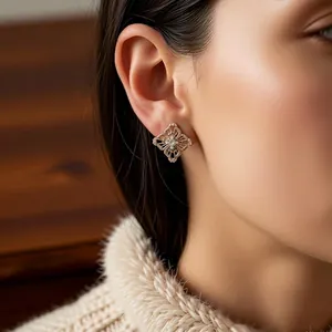 Vintage-style hollow starburst earrings with 18K gold plating and bright zircon stone