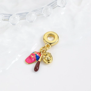 Detail of enamel baseball charm with pink cap, brown bat, and golden glove pendants