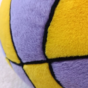 Macro shot of plush basketball pillow showing premium soft texture and black stitching detail