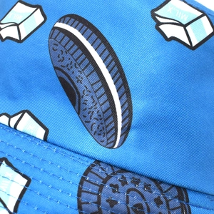 Close-up detail of reinforced stitching on blue bucket hat with milk and cookie print