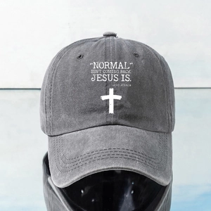 Detail of washed dark grey baseball cap showing white cross and religious text print