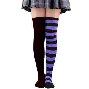 Détail de chaussettes hautes asymétriques en marron foncé et motif à rayures violettes