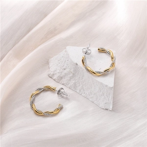 Chic 18K gold plated two-tone twisted C-shape hoop earrings on elegant silk background