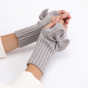 Detail view of grey ribbed knit fingerless gloves featuring a decorative knitted bow design